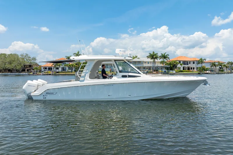 Slide: The Image of 2021 Boston Whaler 350 Realm boat on calm water, clear sky background. - 3
