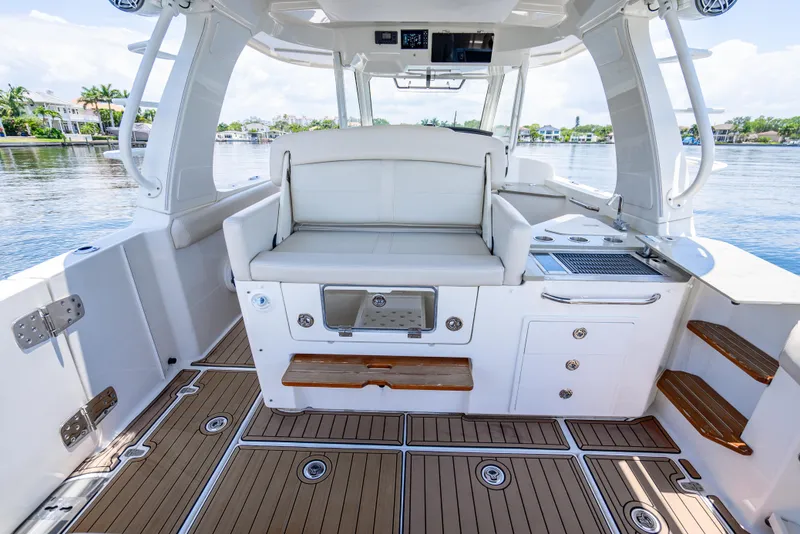 Slide: The Image of 2021 Boston Whaler 350 Realm interior with seating and storage, featuring sleek design and water views. - 35