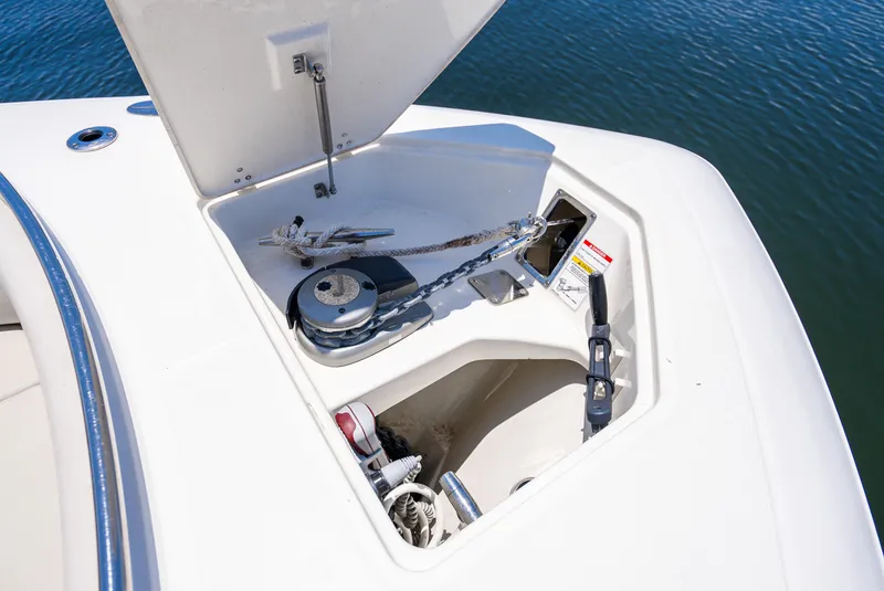 Slide: The Image of Boston Whaler 350 Realm 2021 anchor compartment with winch, open on calm water. - 37