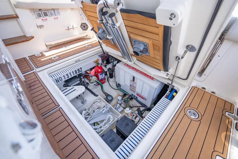 Slide: The Image of 2021 Boston Whaler 350 Realm engine compartment with equipment and storage. - 40