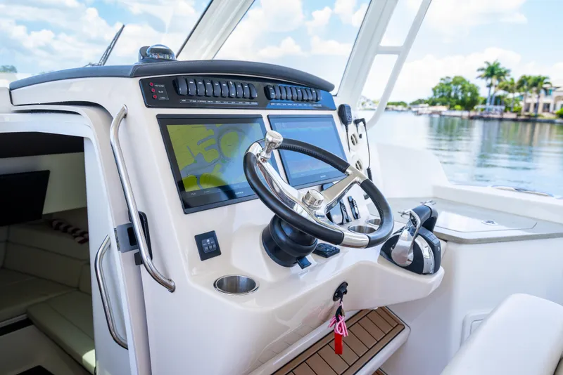 Slide: The Image of 2021 Boston Whaler 350 Realm helm with modern controls and navigation screens. - 9