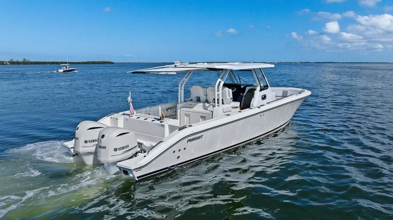 Slide: The Image of 2021 Pursuit S 328 Sport boat cruising on open water under clear skies. - 11