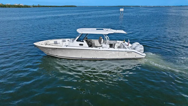 Slide: The Image of 2021 Pursuit S 328 Sport boat cruising on open water. - 13