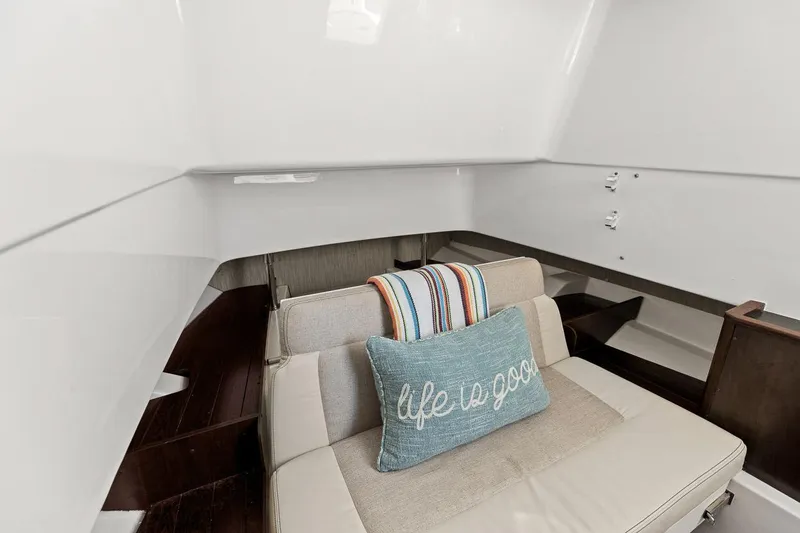 Slide: The Image of Interior of 2021 Pursuit S 328 Sport boat with cozy seating and decorative pillow. - 15