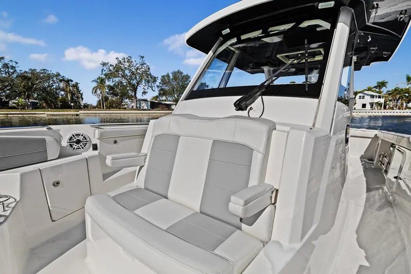 Slide: The Image of 2021 Pursuit S 328 Sport boat interior with cushioned seating and sleek design. - 18
