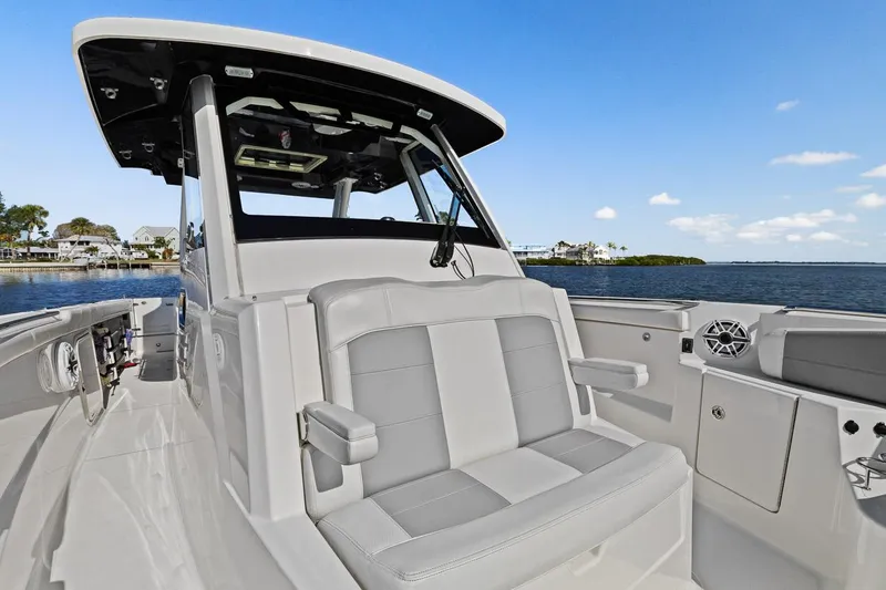 Slide: The Image of 2021 Pursuit S 328 Sport boat with seating, on calm water. - 2