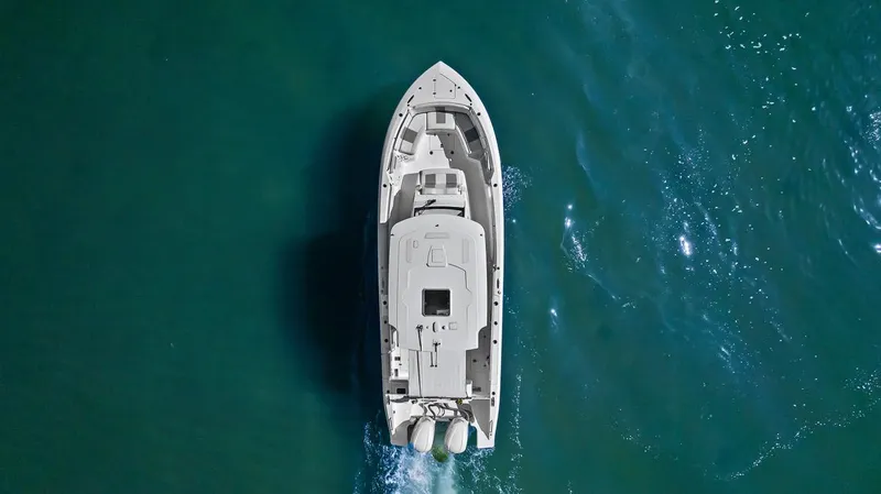 Slide: The Image of Aerial view of 2021 Pursuit S 328 Sport boat cruising on clear blue water. - 21