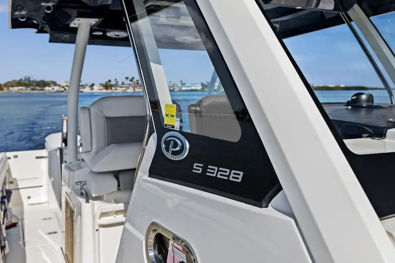 Slide: The Image of 2021 Pursuit S 328 Sport boat on water, showcasing sleek design and luxury features. - 23