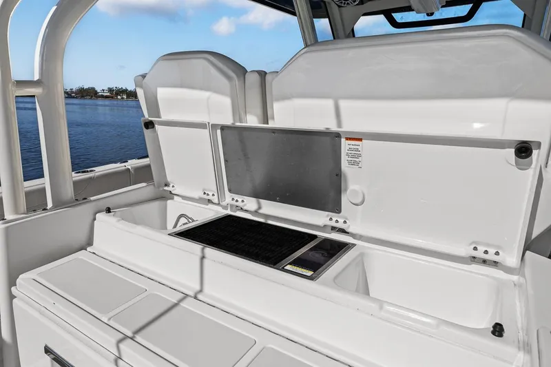 Slide: The Image of 2021 Pursuit S 328 Sport boat interior with open storage compartments. - 29