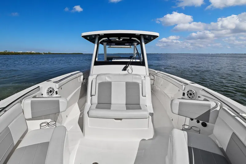 Slide: The Image of 2021 Pursuit S 328 Sport boat interior, featuring sleek seating and open water view. - 35