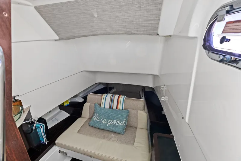 Slide: The Image of 2021 Pursuit S 328 Sport cabin interior with cozy seating and decorative pillow. - 36