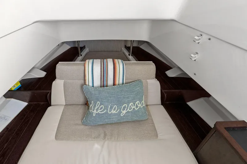 Slide: The Image of 2021 Pursuit S 328 Sport cabin interior with cushion and striped blanket. - 38