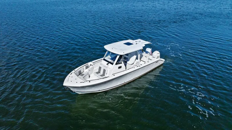 Slide: The Image of 2021 Pursuit S 328 Sport boat cruising on open water. - 7