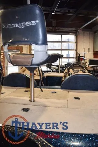 Slide: The Image of Ranger R83 boat interior with seating, 2000 model, in a garage setting. - 12