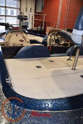 Slide: The Image of Interior of a 2000 Ranger R83 boat with steering wheel and seating. - 14