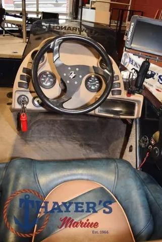Slide: The Image of Interior of a 2000 Ranger R83 boat with steering wheel and dashboard controls. - 22
