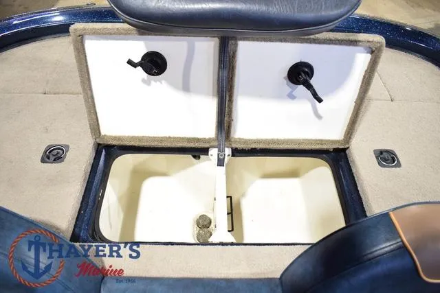 Slide: The Image of 2000 Ranger R83 boat storage compartment with dual hatches, Thayer's Marine logo visible. - 25