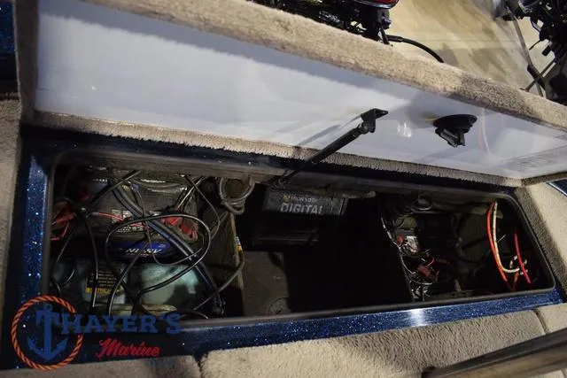Slide: The Image of Open storage compartment in a 2000 Ranger R83 boat, showing wiring and equipment. - 29