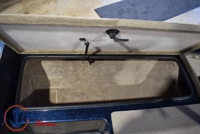 Slide: The Image of Open storage compartment in a 2000 Ranger R83 boat, showcasing interior space. - 30