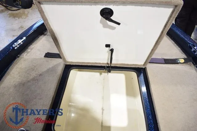 Slide: The Image of Open storage compartment on a 2000 Ranger R83 boat, featuring Thayer's Marine logo. - 31