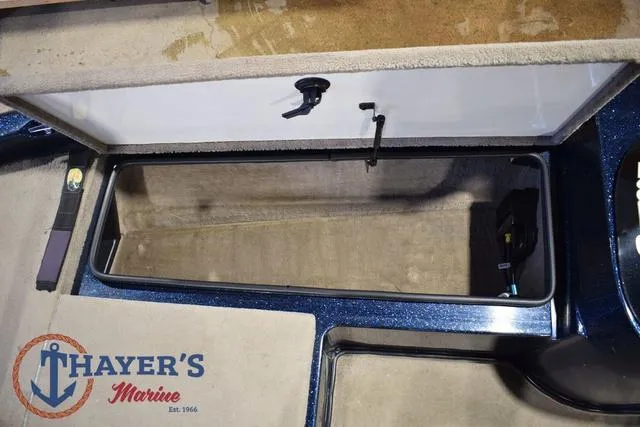 Slide: The Image of Open storage compartment in a 2000 Ranger R83 boat, featuring Thayer's Marine logo. - 32