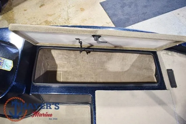 Slide: The Image of Open storage compartment in a 2000 Ranger R83 boat, featuring carpeted interior. - 33