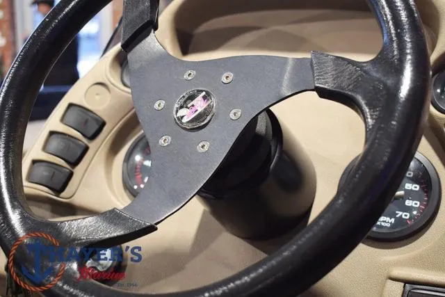 Slide: The Image of Steering wheel of a 2000 Ranger R83 boat, featuring dashboard controls and gauges. - 38