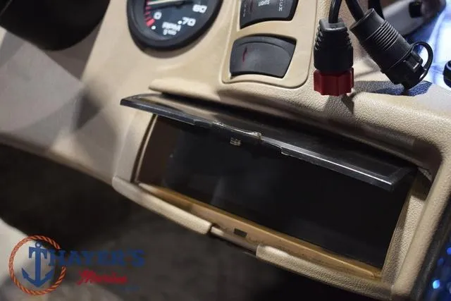 Slide: The Image of Dashboard of a 2000 Ranger R83 boat with open compartment and gauges. - 39