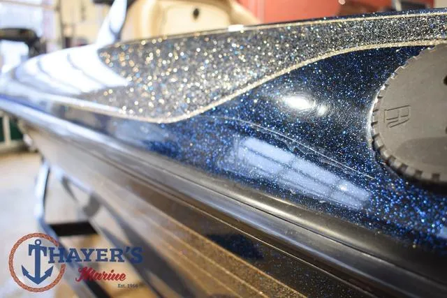 Slide: The Image of Close-up of a 2000 Ranger R83 boat with a sparkling blue finish. - 41