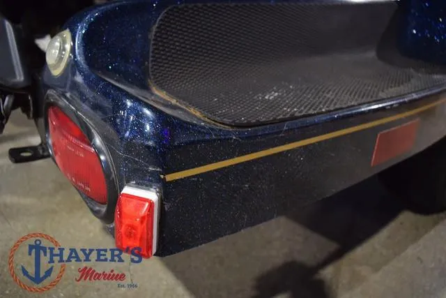 Slide: The Image of Rear view of a 2000 Ranger R83 boat with Thayer's Marine logo. - 42