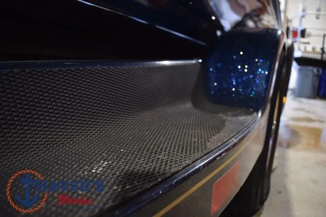 Slide: The Image of Close-up of a 2000 Ranger R83 boat with textured surface detail. - 43