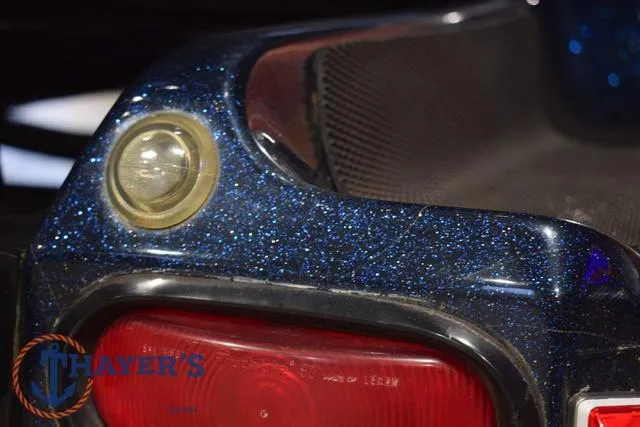 Slide: The Image of Close-up of a 2000 Ranger R83 boat's glittery blue rear with taillight. - 48