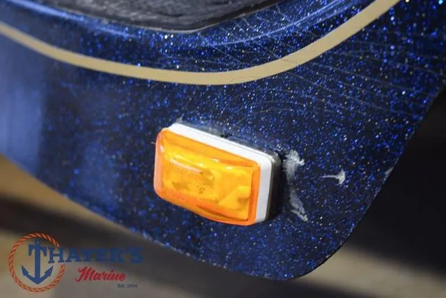 Slide: The Image of Close-up of a 2000 Ranger R83 boat with orange side marker light. - 49