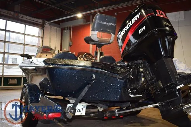 Slide: The Image of 2000 Ranger R83 boat with Mercury 175 engine in a garage setting. - 6