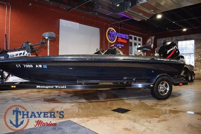 Slide: The Image of Ranger R83 boat, 2000 model, displayed indoors at Thayer's Marine showroom. - 7