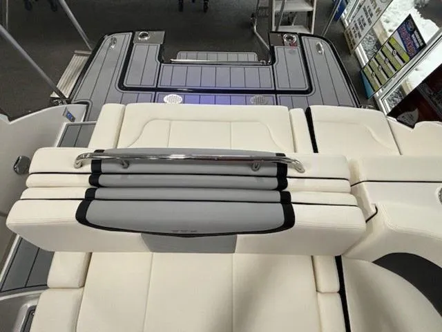 Slide: The Image of 2024 Chaparral 287 SSX boat interior with white and gray seating. - 11