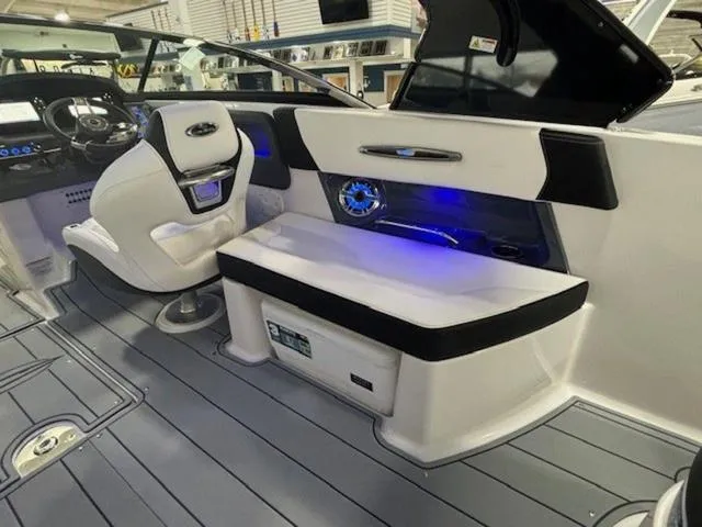 Slide: The Image of 2024 Chaparral 287 SSX boat interior with modern seating and illuminated dashboard. - 12