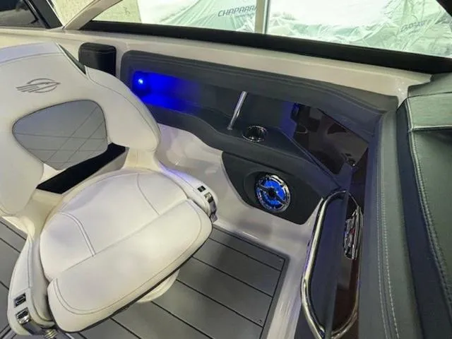 Slide: The Image of 2024 Chaparral 287 SSX interior with white seating and blue LED lighting. - 15