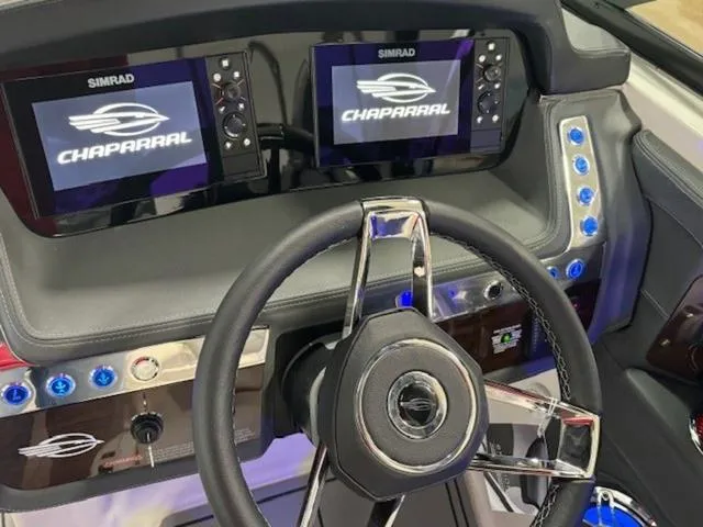 Slide: The Image of 2024 Chaparral 287 SSX dashboard with dual Simrad displays and sleek steering wheel. - 16
