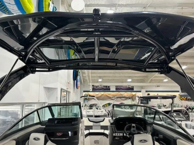 Slide: The Image of 2024 Chaparral 287 SSX boat interior with sleek black canopy and modern dashboard. - 17