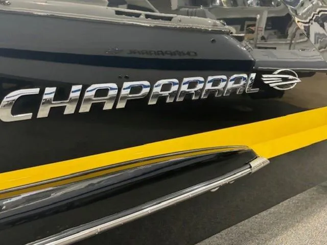 Slide: The Image of 2024 Chaparral 287 SSX boat with sleek design and chrome logo detailing. - 18