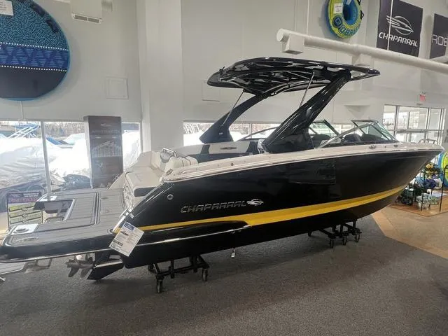Slide: The Image of 2024 Chaparral 287 SSX boat displayed indoors, featuring sleek black and yellow design. - 20