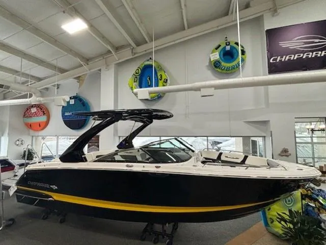 Slide: The Image of 2024 Chaparral 287 SSX boat displayed indoors with colorful inflatables on the wall. - 4