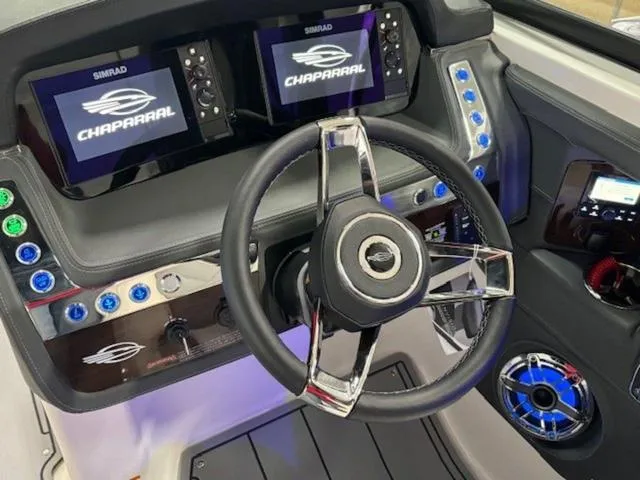 Slide: The Image of 2024 Chaparral 287 SSX dashboard with dual Simrad displays and modern steering wheel. - 5