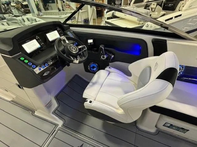 Slide: The Image of 2024 Chaparral 287 SSX boat cockpit with modern controls and luxurious seating. - 6