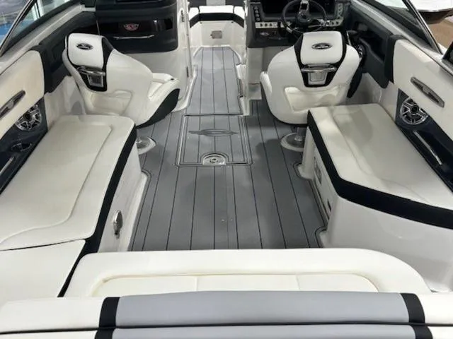 Slide: The Image of 2024 Chaparral 287 SSX boat interior with luxurious seating and modern dashboard. - 8
