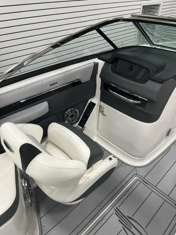 Slide: The Image of 2024 Chaparral 267 SSX boat interior with sleek white and black seating. - 13