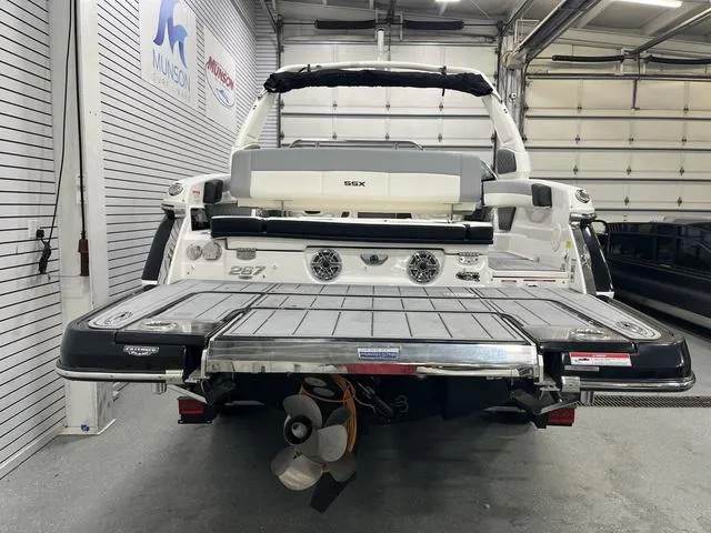 Slide: The Image of 2024 Chaparral 267 SSX boat in showroom, rear view with swim platform and propeller. - 5