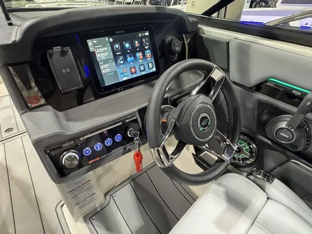 Slide: The Image of 2025 Chaparral 2870 SSX boat dashboard with touchscreen display and modern controls. - 10