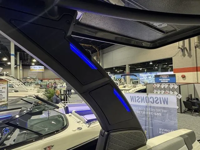 Slide: The Image of 2025 Chaparral 2870 SSX boat interior at a showroom with modern design features. - 13